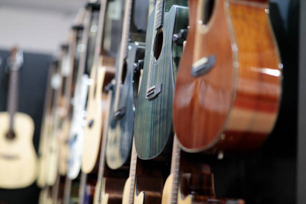 istock acoustic guitars hanging on a wall in music store 1727439862