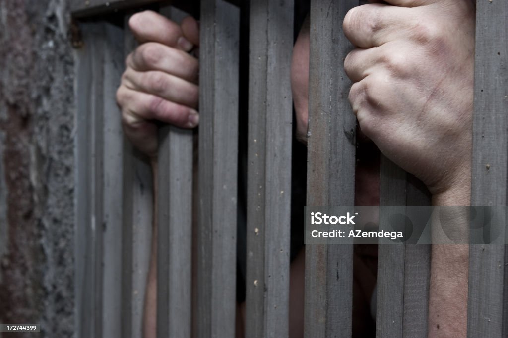 Prisoner hands Man behind prison bars Anger Stock Photo