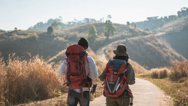 istock Travelers hiking with backpack traveling in forest wild and look around and explore while walking in nature wood. happy holiday vacation trip. 1727448934