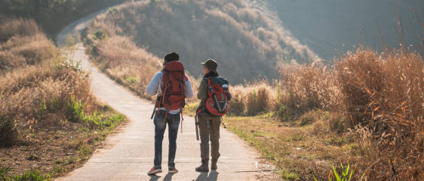 istock Travelers hiking with backpack traveling in forest wild and look around and explore while walking in nature wood. happy holiday vacation trip. 1727450835