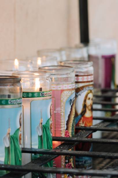 istock several candles of religious icons on the table in front of them 1727452528
