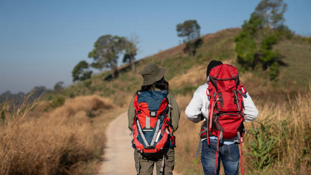 istock Travelers hiking with backpack traveling in forest wild and look around and explore while walking in nature wood. happy holiday vacation trip. 1727452546