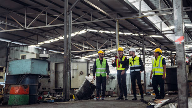 Mechanical Team Operating Machinery in a Manufacturing Workshop. Workers, Equipment, and Quality Control for old factory.