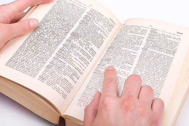 student's hand zeigt ein wort - english dictionary stock-fotos und bilder