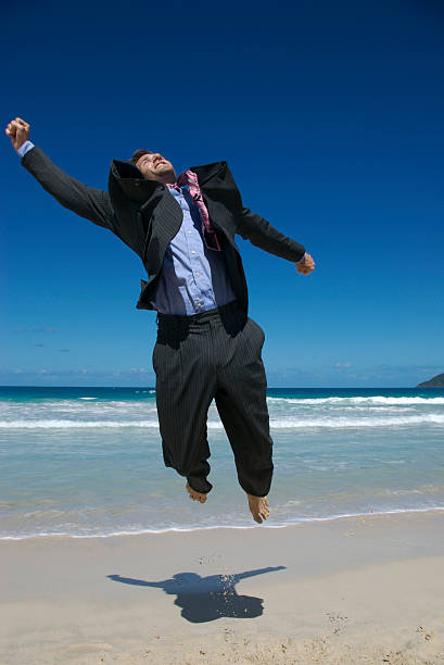 istock Excited Young Man Businessman Jumping on Tropical Beach 172745958
