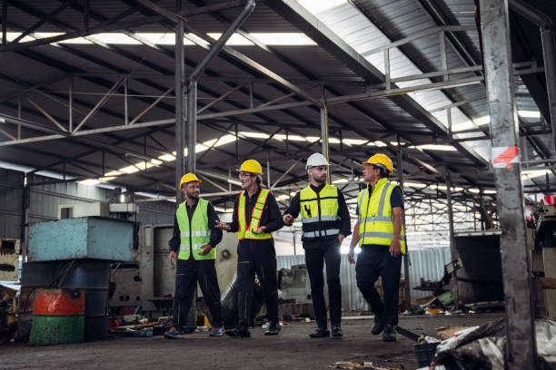 istock Mechanical Team Operating Machinery in a Manufacturing Workshop. Workers, Equipment, and Quality Control for old factory. 1727459645