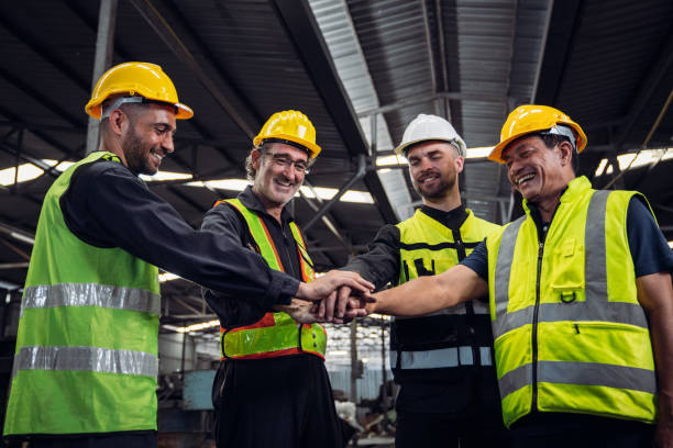 istock Team engineers and foreman stack hand and shake hands to show success at factory machines. Mechanical Team Operating Machinery. 1727462902