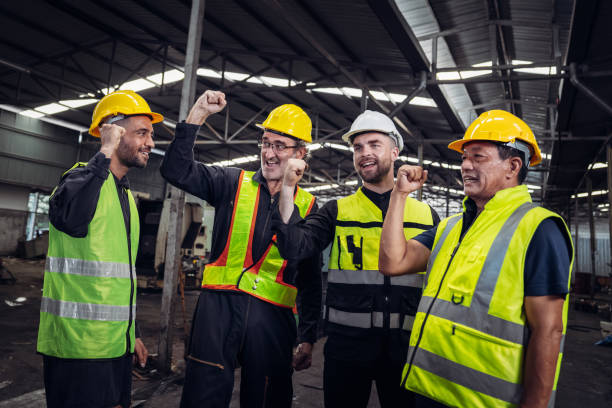 istock Team engineers and foreman stack hand and shake hands to show success at factory machines. Mechanical Team Operating Machinery. 1727464593