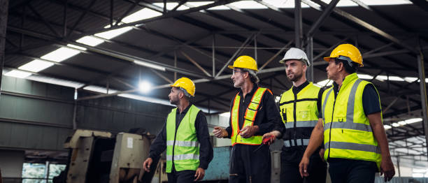 istock Mechanical Team Operating Machinery in a Manufacturing Workshop. Workers, Equipment, and Quality Control for old factory. 1727465182