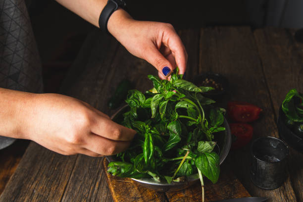 istock Girl cutting vegetables on a wooden board 1727476201