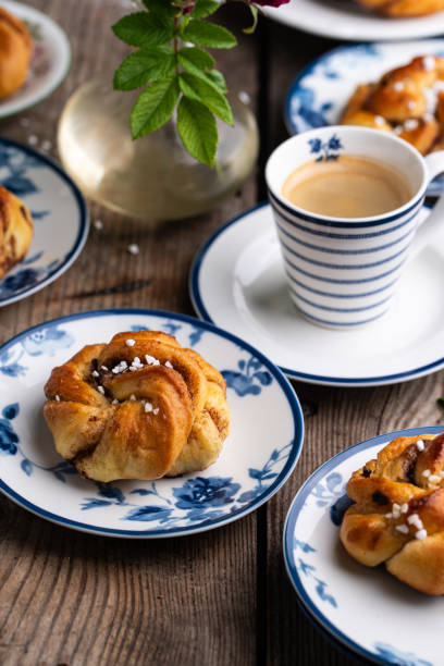 istock Traditional cinnamon buns on porcelain plates and coffee. 1727476245