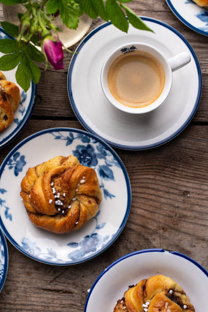 istock Traditional cinnamon buns on porcelain plates and coffee. 1727476252