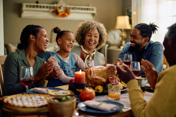 istock Cheerful multigeneration family having fun during Thanksgiving dinner at dining table. 1727476836