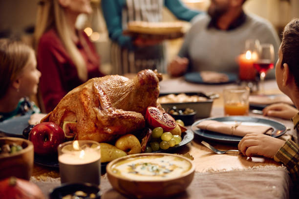 istock Roast turkey on dining table during family meal on Thanksgiving. 1727479044