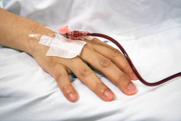 Blood transfusion Patient recieving new blood intravenously. tracheotomy tubing stock pictures, royalty-free photos & images