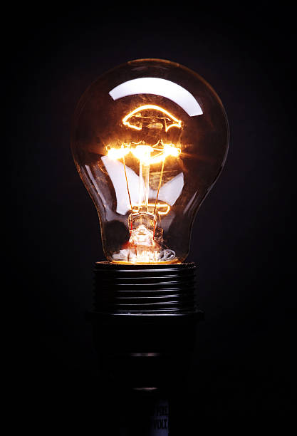 istock The sparks of a lit light bulb over a black background 172748188