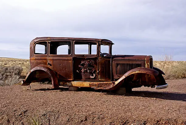 A rusty vintage car is a monument to the historic Route 66 in Arizona. Located in the Petrified Forest National Park and accessible from exit 313 on Interstate Highway 40 between Gallup, New Mexico and Holbrook, Arizona.