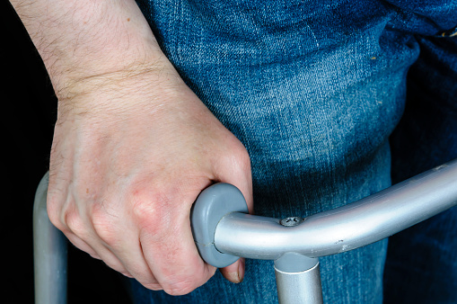 Young  man using a Zimmer walking frame in his own home