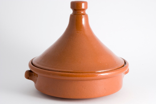 Studio shot of an old used traditional clay cooking pot on a neutral background