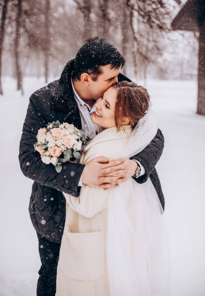 istock Winter wedding. Newlyweds walking outdoors at winter time 1727500634