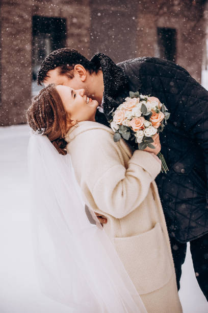 istock Winter wedding. Newlyweds walking outdoors at winter time 1727500636
