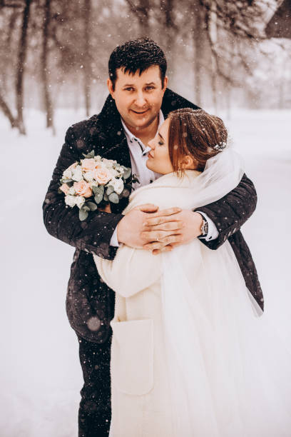 istock Winter wedding. Newlyweds walking outdoors at winter time 1727500638
