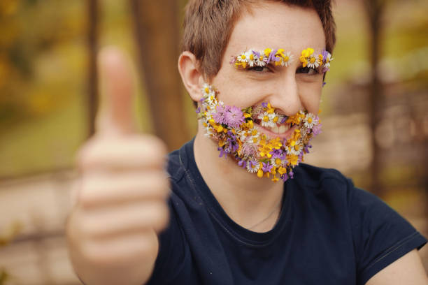 In the imagery, spring flowers replace a young man's facial hair. With nature-infused brows and beard, he confidently flashes a thumbs-up, urging trust in his spiritual connection