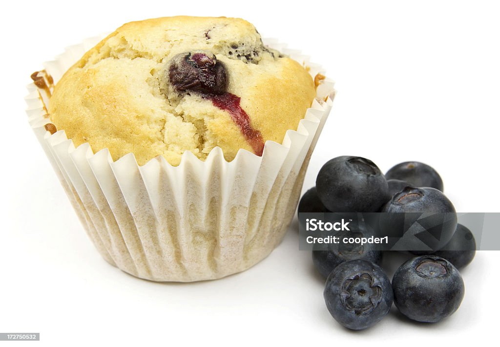 Blueberry Muffins A blueberry muffin alongside blueberries on a white background. Baked Stock Photo