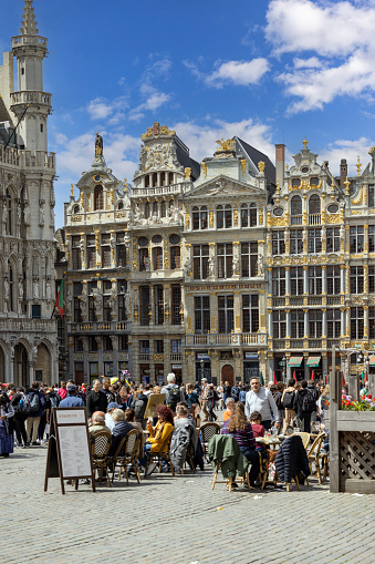 Brussels, Belgium - May 17, 2023: Tourist in Grand Place, main market in the city. It is surrounded by baroque tenement houses of the old Brussels guilds
