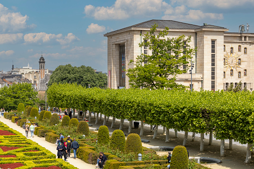 Brussels, Belgium - May 18, 2023: Mount of the Arts (Mont des Arts), view of colorful garden, people walking along the alleys