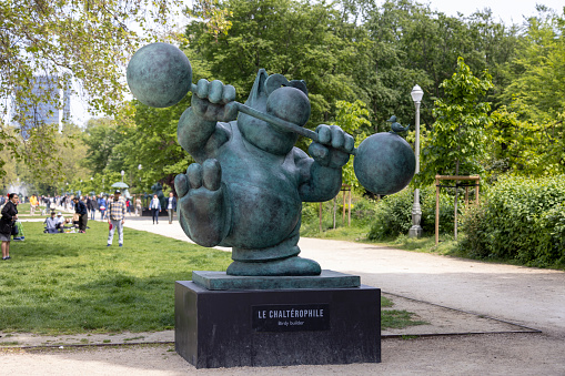 Brussels, Belgium - May 18, 2023: One of the sculpture of the famous belgian comic book character of a big cat, Le Chat in Royal Park. Character created by Philippe Geluck