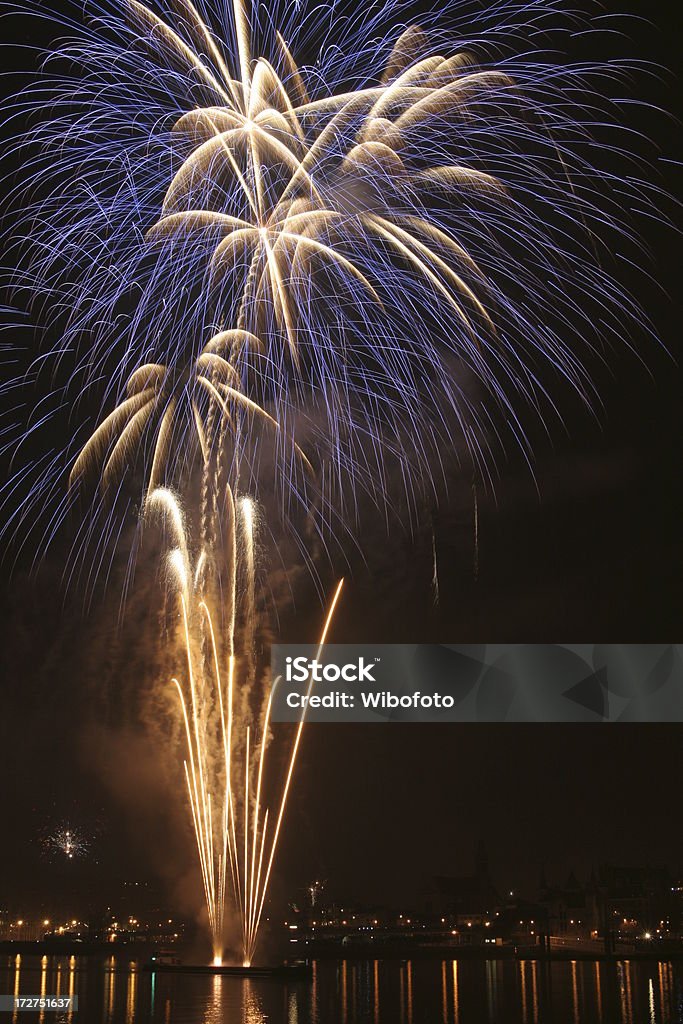 Blue firework exploding Blue firework exploding with water reflection. Backgrounds Stock Photo