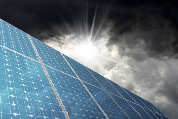 istock Group of Solar Panels with Storm Clouds on Background 1727523253