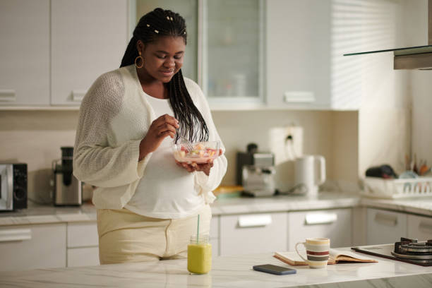 istock Pregnant Woman Eating Fruit Salad 1727523271