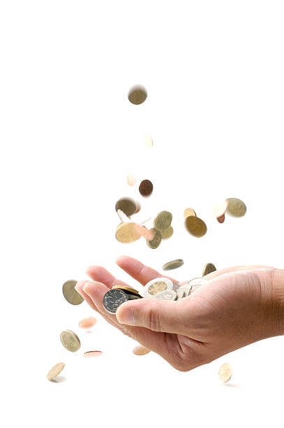 istock Close up of cupped hand collecting falling coins 172752487
