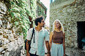 Happy millennial couple, exploring the historic village of Eze in the south of France, while on vacation.
