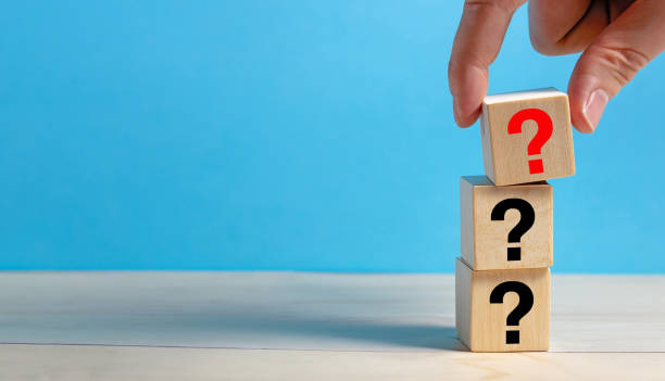 istock Question Mark concept. Hand holding question mark on wooden cube block. 1727542878