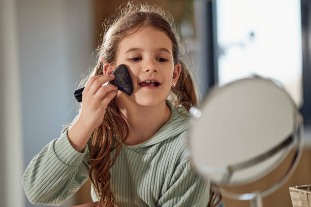 istock Happy girl applying make up 1727543432