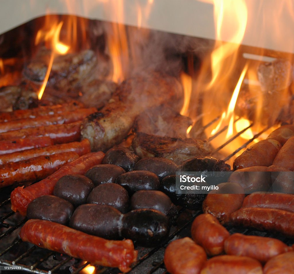 Barbecue cooking sausages on a grill. Please see some similar pictures in my lightboxs: Barbecue - Meal Stock Photo