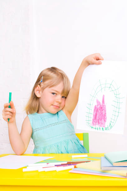 istock Girl proudly holding up her artwork 172754642