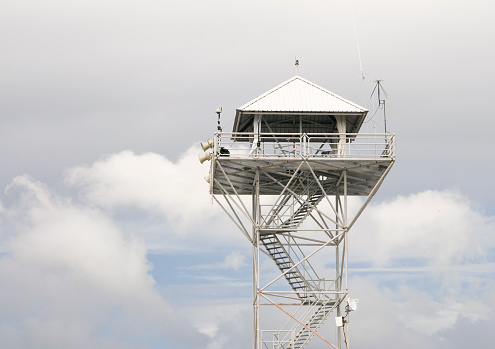 A tall guard tower at an airfield.