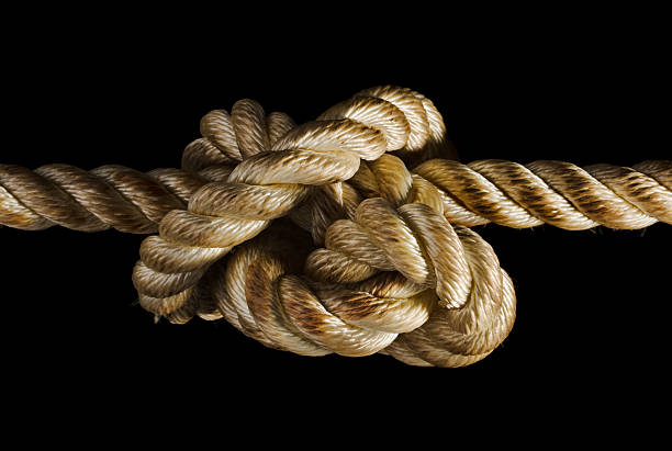 cuerda nudo que expresan el estrés, la adversidad, tensión, tracción sobre negro - tied knot rope adversity emotional stress fotografías e imágenes de stock