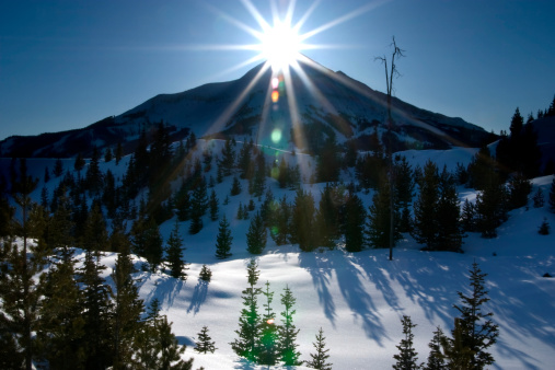 Mountain peak and sun.