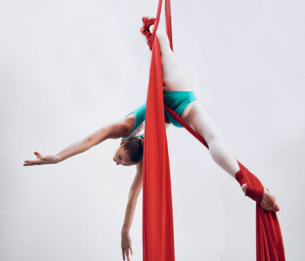 istock Aerial, woman gymnast and training performance with stretching, flexibility split and athlete with white background. Workout, exercise and gymnastics with balance art and dance acrobat competition 1727562198