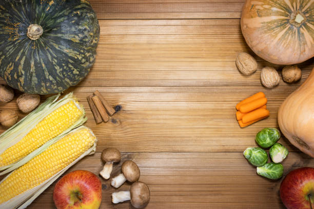 Autumn composition. Pumpkins, apples, walnuts on wooden table. Thanksgiving day concept. Top view.
