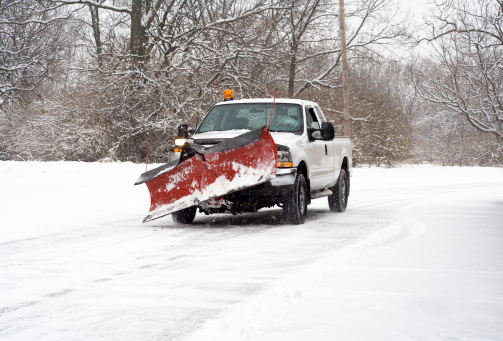 Pick-up truck on its way to plow the roads during a snow storm