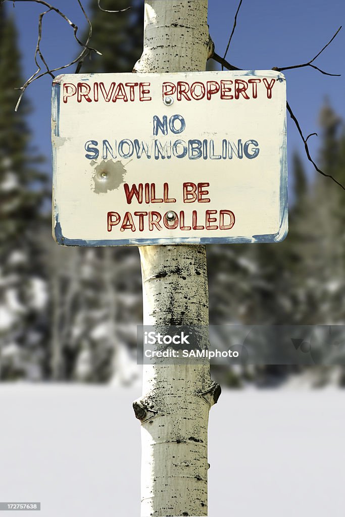 No Snowmobiling "Sign posted, with a bullet hole." Adventure Stock Photo