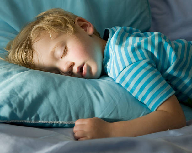 istock Young boy in blue, peacefully sleeping on a blue pillow 172757774