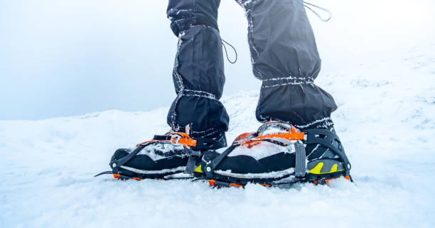 istock Man trekking snowy mountain using crampons 1727579127