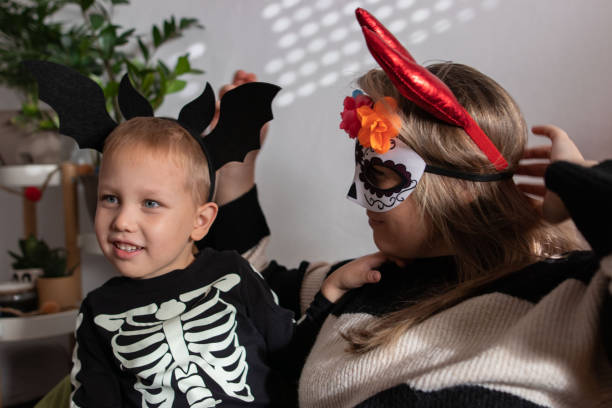 istock Beautiful brunette single mom and her toddler having a fun on halloween day 1727580310